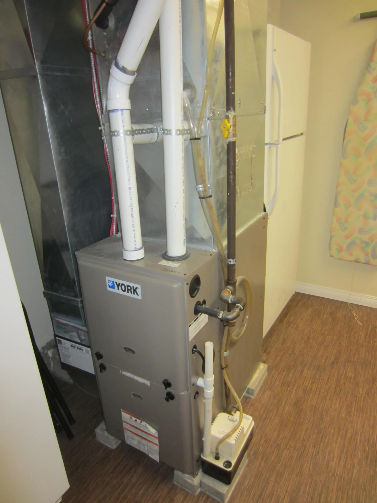 Residential condensing gas furnace with ductwork and vent pipes