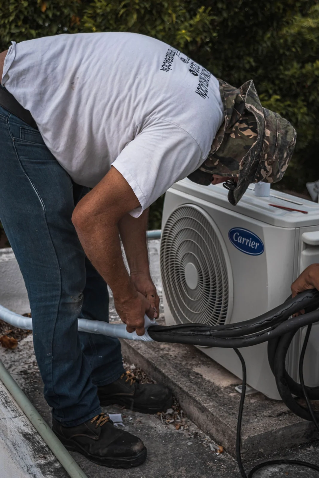 Hands insulating pipework for an air conditioning system